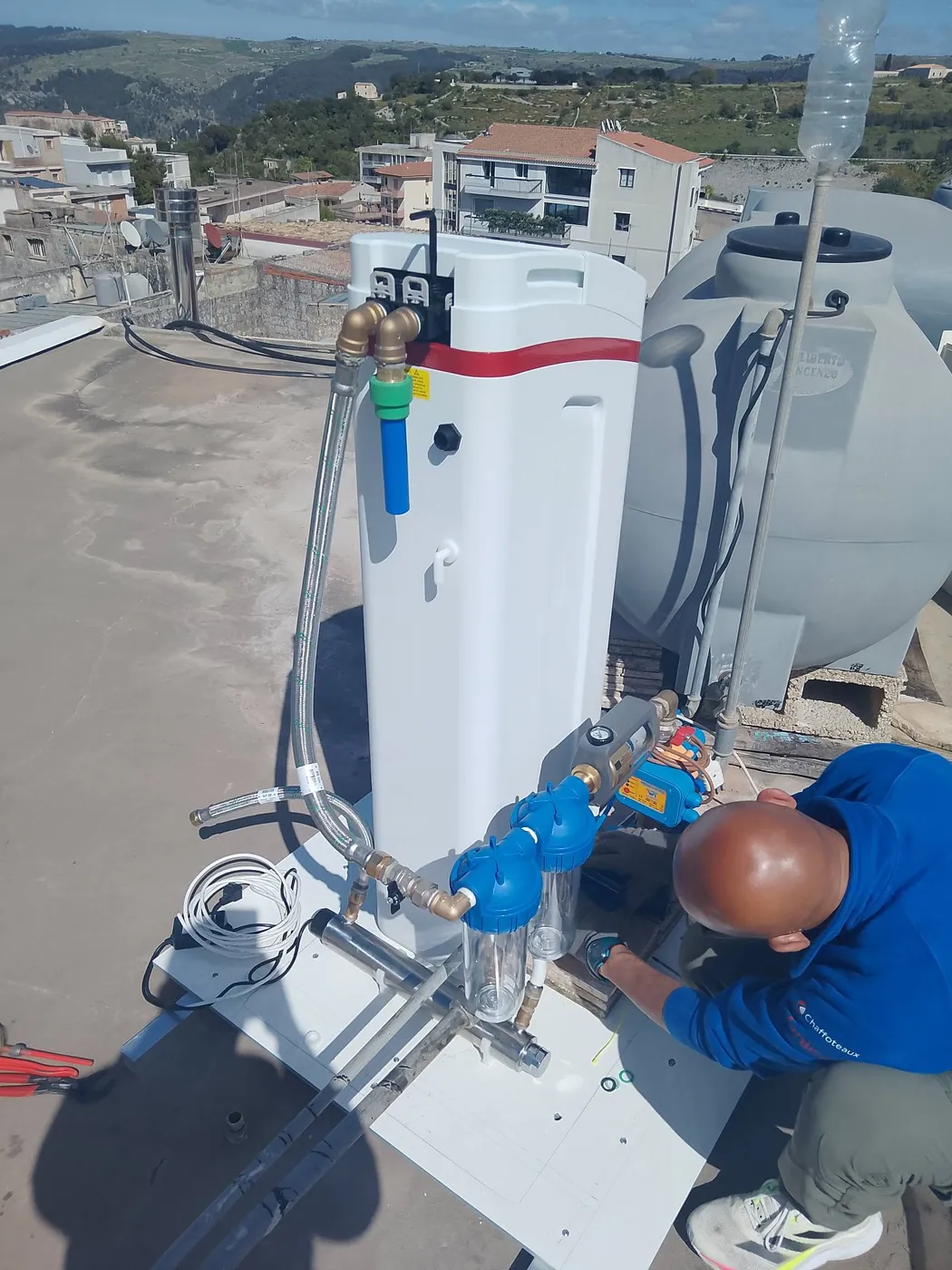 IlmaaPure technician fitting a system on a rooftop